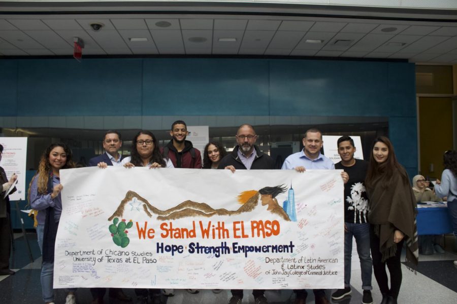 Students and faculty stand with the solidarity El Paso poster in the Atrium - Damba Yansane